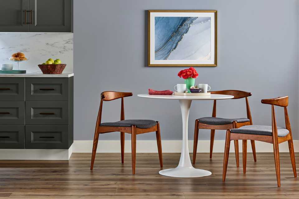 kitchen table in modern kitchen with blue wall and hardwood floors